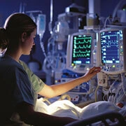 Diagnostic support in ICCU with doctor reviewing cardiac test reports and monitoring patient vitals