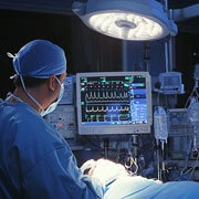 ICU nurse monitoring patient after neurosurgery with continuous vital signs observation