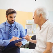 Doctor conducting preventive health checkup and counseling adult patient in hospital