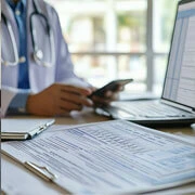 Hospital admission desk verifying required documents including ID proof, insurance policy, and medical records