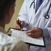 Doctor explaining hospital discharge summary including diagnosis treatment medication and follow-up instructions to patient